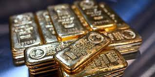 Gold bars and coins representing the current gold price rally