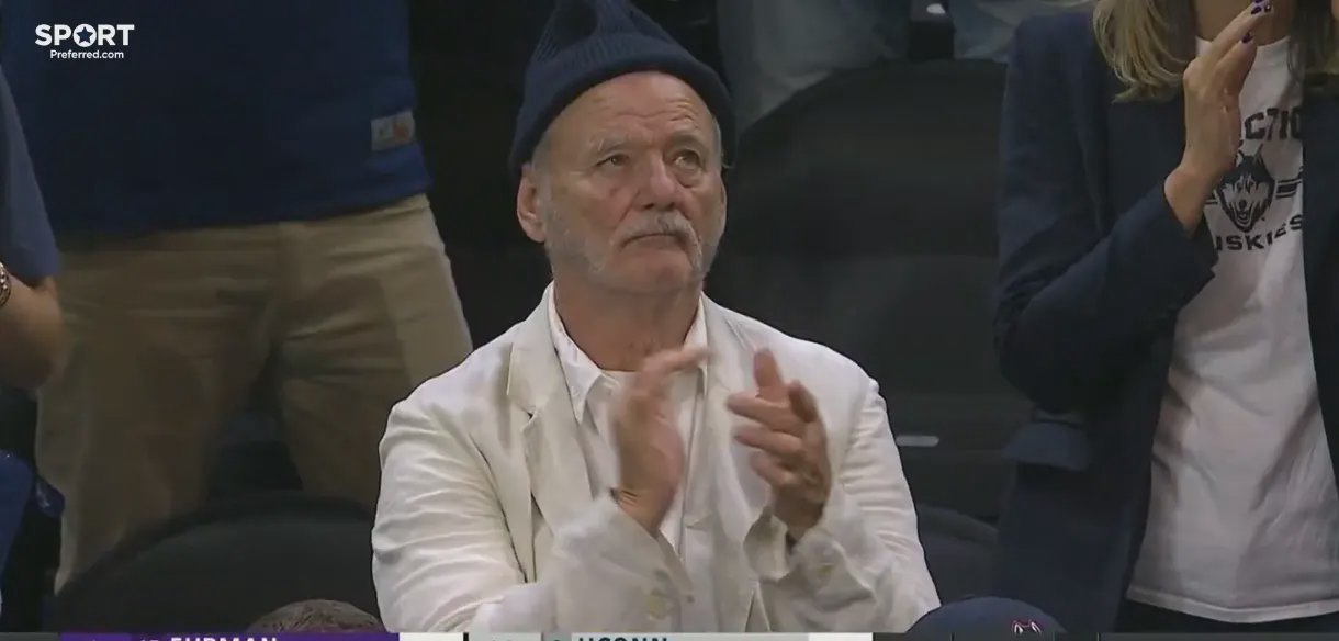 Bill Murray sits courtside at the UCLA vs UConn March Madness game supporting his son Luke Murray