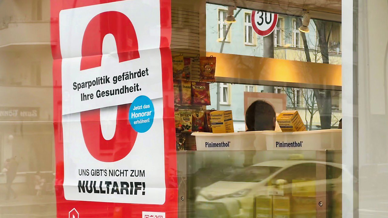 Locked pharmacy with protest sign