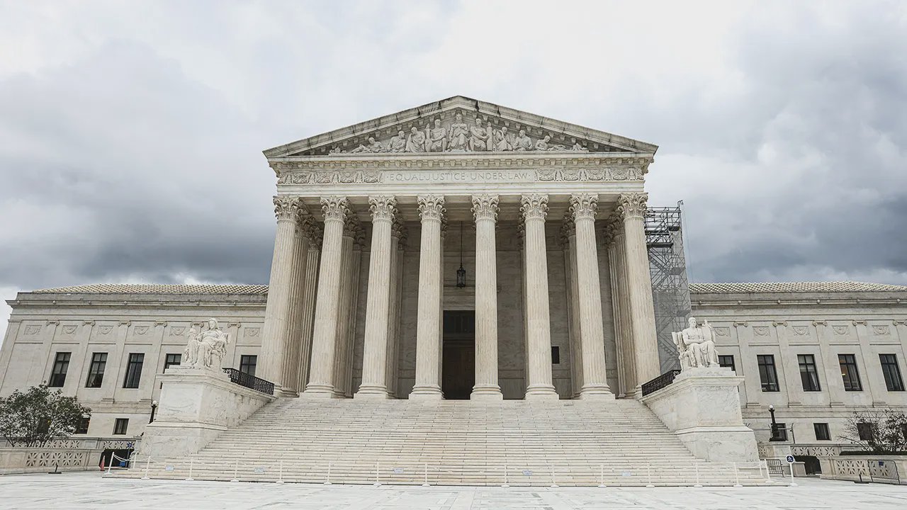 The facade of the U.S. Supreme Court shrouded in clouds