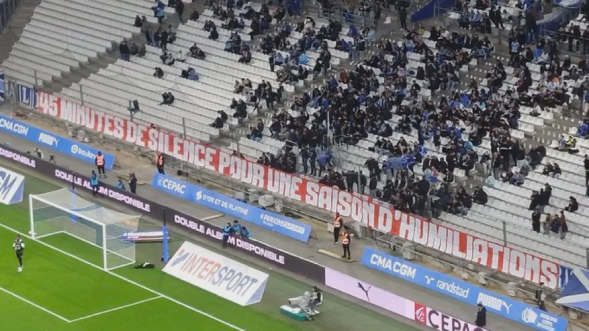 Marseille fans holding banners in a silent protest at the Vélodrome
