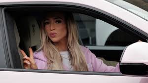 GK Barry posing with her pink Lamborghini