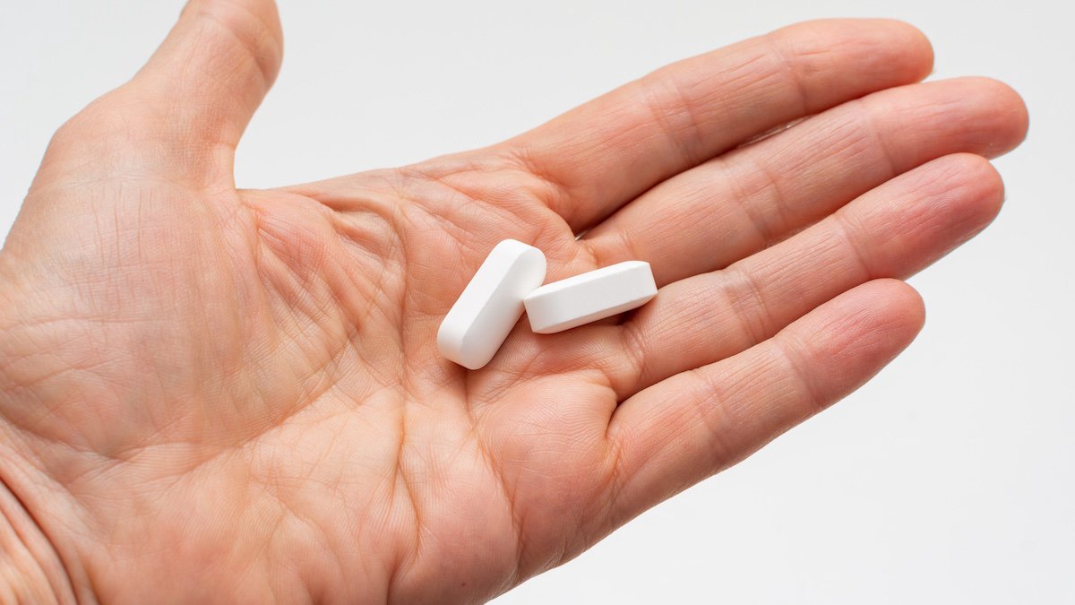 A hand holding pills, symbolising new obesity medications
